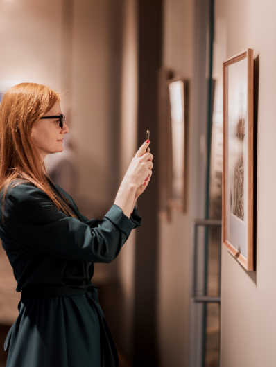 a art manager maison helya takes a photo of a work to offer it to her client