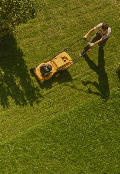 a maison helya landscape gardener uses the mower in the park of an exceptional property